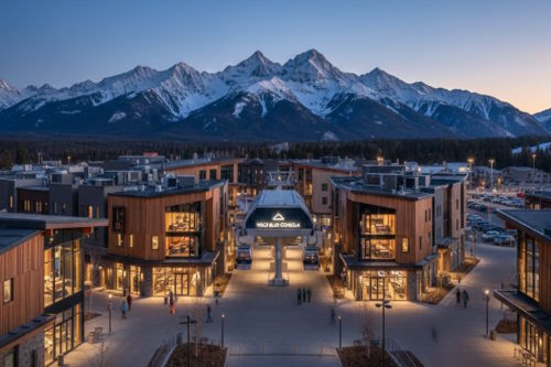 Modern ski resort base village at twilight, featuring sustainable wooden architecture, a glowing gondola station, and integrated mixed-use infrastructure in a mountain landscape.
