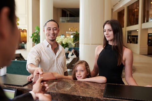 Family checking into a modern family hotel, highlighting stress-free arrival and guest experience