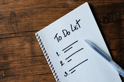 hospitality business for sale preparation checklist on notebook with pen